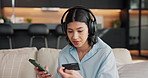 Headphones, phone and woman on sofa with credit card, online shopping and digital banking with music. Happy, home and person on mobile app with audio for payment, transaction and website on weekend