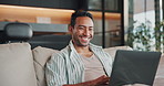 Smile, man and relax on sofa with laptop, streaming and watching trailer of new movie releases. Happy, male person and laughing in home with tech, upcoming film and internet search for trending video
