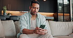 Texting, online and man with phone in home, reading and communication with contact on social media. Typing, message and person with mobile, networking and internet search on website or chat on app