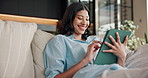 Happy, woman and relax on sofa with tablet, streaming and watching trailer of new movie releases. Female person, rest and laugh in home with tech, upcoming film and internet search for trending video