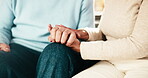 People, holding hands and support or empathy in home for connection, trust or understanding. Couple, affection and together for loyalty, partnership and help in house for kindness, respect or care