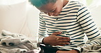 Hands, child and stomach ache in home, sick or uncomfortable with irritable bowel syndrome. Health risk, abdomen pain and boy with constipation, gas bloating or diarrhea problem with food poisoning