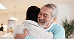 Hug, happy and man with senior father in home with bonding, connection or good news together. Smile, love and adult son embracing elderly dad in living room for support, trust or family in house.