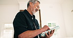 Smile, man and remote work at house with tablet, research and source consent for story submission. Mature person, review and freelancer in home with digital, editing grammar and publication approval