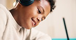 Happy, child and headphones with writing for homework, streaming music and learning from assignment. Boy, smile and taking notes in home for academic project, education and audio tech for radio song.