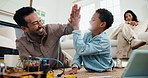 Child, father and high five with toy car for robotics, tablet or online tutorial for remote control in home. Family, son and dad with tech for guide with engineering, junior mechanic or development