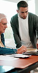 Senior, dad or finance with adult son in home for help, accounting or budget planning together. Elderly, father or discussion with man, laptop or documents for financial advice or assistance in house