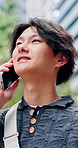 Student, conversation and Asian man in city with phone call, connection or travel outdoor to college. Low angle, person and mobile tech with contact, discussion and commute to university in Japan.