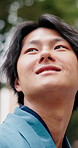 Happy, sightseeing or asian man with vision in nature for travel adventure or outdoor journey. Thoughtful, male person or thinking with wonder or smile for trip, ambition or commute in Tokyo or Japan