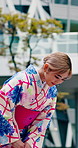 Asian woman, greeting and bow in city with kimono, respect and etiquette for cultural heritage. Japanese person, tourist or polite gesture with traditional clothes, honor custom and farewell ceremony