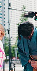 Asian people, greeting and bow in city with kimono, respect and etiquette for cultural heritage. Japanese man, woman and polite gesture with traditional clothes, welcome tourist and farewell ceremony
