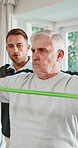 Physiotherapy, stretching and senior man with exercise for rehabilitation, healing and fitness. Healthcare worker, patient and consultation with resistance band, physio and muscle relief at clinic