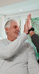 Physiotherapy, stretching and senior man with high five for rehabilitation, healing and fitness. Healthcare professional, patient and consultation with support, physio or celebrate progress at clinic