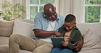Relax, tablet and dad with child on sofa for bonding with online game, internet and connection. Family, home and African father with boy on tech for educational app, playing and happy on weekend