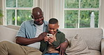 Happy, phone and dad with child on sofa for bonding with online game, internet and connection. Family, home and African father with boy on cellphone for relationship, playing and relax on weekend