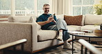 Phone, relax and man on sofa in home with texting, networking or reading blog on mobile app. Happy, technology and mature person with cellphone for communication, feedback or contact in living room.