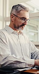 Laptop, typing and man in office for research, thinking or asset management report. Computer, planning and mature person in company for financial review, email draft or project insight on website