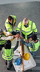 Architect, celebration and hand stack with team, above or blueprint for project on construction site. Civil engineer, win and collaboration with colleagues, clapping and happy people with paperwork
