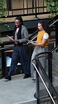 People, talk and tablet on stairs with sustainable business, explain project and team collaboration. Coworkers, walk or discussion in office with tech, eco friendly proposal or environmentalist work.