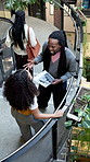 Happy, documents or friendly conversation in office building for greeting, goodbye or chat together. People, employees or colleagues with hello on staircase for business discussion in workplace