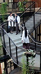 Doctors, team and talk on staircase with tablet, research and medical opinion on test results. People, walk and collaboration at hospital with digital, patient case and treatment plan for healthcare