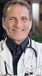Face, man and doctor in hospital with smile, medical advice and cardiologist for heart disease. Portrait, mature surgeon or arms crossed in workplace for cardiology, assistance and healthcare service