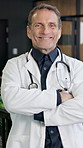 Happy, man and doctor in hospital with face, medical advice and cardiologist for heart disease. Portrait, mature surgeon or arms crossed in workplace for cardiology, assistance and healthcare service