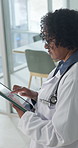 Woman, doctor and walking with tablet in hospital for medical assessment, exam or results. Female person, healthcare worker or research with technology for patient history or health study in clinic