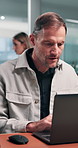Business, man and lawyer in office with laptop, research and witness statement for legal precedents. Mature attorney, typing and coworking at firm with pc, court case and evidence report for justice