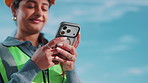 Phone, construction worker or hands outdoor with engineering app, design space and typing. Mobile, smile and woman with architecture review for text message, project communication and low angle