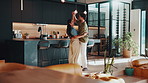 Dancing, happy and couple in kitchen at house for bonding, connection or marriage on weekend. Smile, love and man with woman for moving to music, playlist or radio for relationship together in home.
