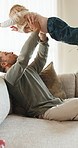 Happy, father and lift baby in house with care, trust and play for bonding together on weekend break. Man, son and smile in living room with airplane game, connection or support for child development