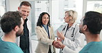 Happy, people and doctor with handshake in meeting for medical partnership or funding hospital. Investor, healthcare team or shaking hands with smile for b2b, investment or introduction in clinic