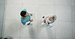 Doctor, laughing or discussion with nurse in hospital for funny joke, humor or friendly conversation. Top view, man and woman talking with clipboard for comedy or interaction together in clinic