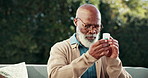 Black man, reading and pills with container for prescription, information or dosage outdoor. Senior person, patient and medication tablets for pharmaceuticals, medical plan or treatment in backyard