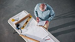 Above, man and engineer with clipboard for construction, survey and inspection report for safety. Mature person, reading or document at site with checklist, compliance contract and building expansion