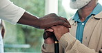 Home, caregiver and old man holding hands with cane, support or assurance for injury rehabilitation. Nurse, help and senior person with disability, walking stick and healthcare for assisted living.