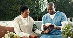 Nurse, checkup and woman at house for blood pressure, screening and vital signs of hypertension. Caregiver, monitor and mature person in backyard with device, assessment and track oxygen for wellness