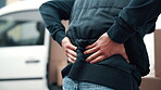 Logistics, delivery or hands outdoor with back pain, spine issue or labor injury in distribution. Backache, man or courier with package lifting, physical strain or muscle discomfort in supply chain.