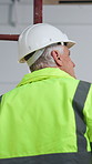 Back, thinking and man with helmet for renovation, construction project and remodeling in building. Safety, supervisor and mature person with ppe for property inspection, compliance and architecture