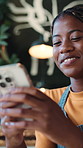 Text, laugh and barista in cafe with phone, funny chat and social media update on work break. Happy, waitress or black woman in bistro with tech, hospitality meme or online communication in free time