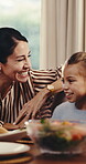 Laughing, food and mother with child in home for thanksgiving celebration, smile and relax. Happy, festive holiday and nutrition with woman and kid in dining room in family house for lunch for love