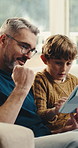 Father, child and celebration in home with tablet, win knowledge game and learning digital literacy. Man, son and fist pump in living room with tech, online educational gaming and bonding for growth.