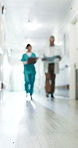 Medical, doctor and team in hospital with folder, insurance and healthcare results for Telehealth. Blurred, people and nurse with clipboard for collaboration, patient record and opinion for treatment