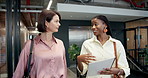 Talking, paperwork and business women in office walking for feedback, project update and conversation. Team, workplace lobby and people with documents for discussion, chat and meeting in morning