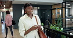 Walking, office and woman with phone in hallway for planning day, networking and email notification. Happy, greeting and business person on cellphone for work schedule, online agenda and research