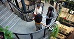 Talking, stairs and business people in office walking with greeting, conversation and arrive with team. Above, workplace and women with tablet for discussion, chat and meeting in morning at company