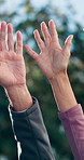 People, unity and community with hands raised in nature for interaction or social participation. Group, friends or senior team with arm up for outdoor engagement, inclusion or effort together in park