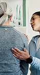 Physiotherapy, consulting and senior patient with shoulder pain, osteoarthritis and recovery in clinic. Healthcare, support and woman with elderly person for physical therapy, wellness and healing