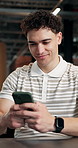 Man, phone and typing in office with smile for project management at web design company. Person, tech and message with agreement, discussion review and feedback negotiation at creative agency